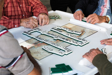 Senior men play the domino game in the historic Domino Park in popular Little Havana in Miami,...