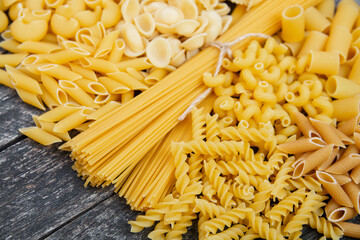 Variety types and shapes of raw Italian pasta - traditional italian Food background