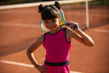 portrait of a cute girl and wearing her tennis racket behind her head