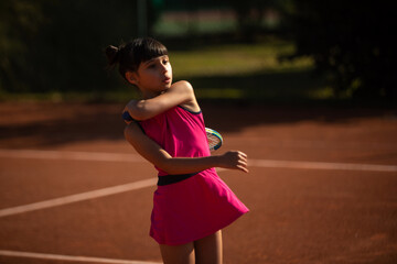 girl concentrated on tennis court and playing tennis