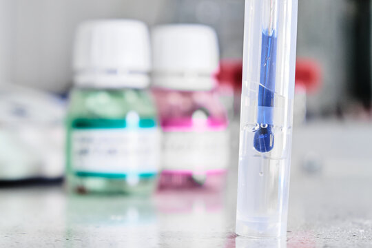 pH meter with glass electrode for measuring of alkalinity and acidity with calibration solution on the background. Analytical or electro chemistry laboratory