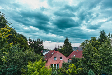 Fototapeta na wymiar Modern german houses against dramatic sky