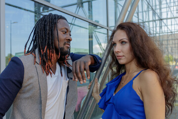 Close-up portrait, outdoors. mixed couple, African and European Caucasian.