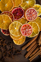 Dry slices of orange, cinnamon and anise on a wooden dish