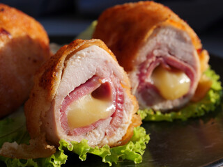 Chicken cordon bleu schnitzel, meat wrapped around ham and cheese, breaded and fried.