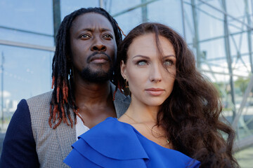 Close-up portrait, outdoors. mixed couple, African and European Caucasian.