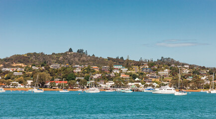 View of Russell in Bay of Islands with residential buildings and boats  - Panorama in Northland, North Island, New Zealand