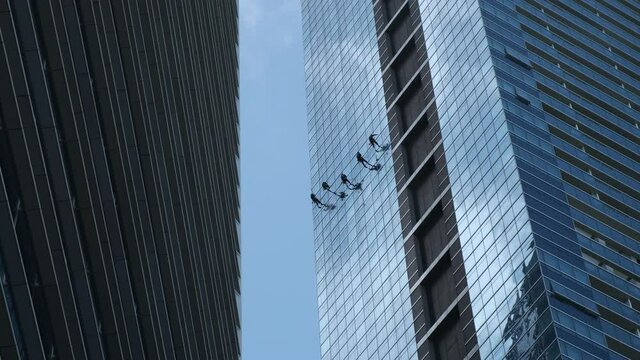 Steeplejacks working on a frontispiece of a skyscraper