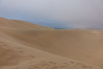 Fototapeta na wymiar NAMIBIA - SANDWICH HARBOUR - DESERT DUNES AND SEA.