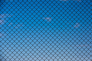 Wire fence and blue sky background