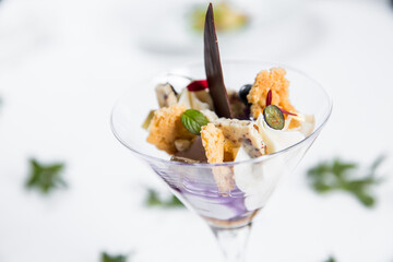 Dessert with biscuits, chocolate and ice cream. Modern cake in a glass