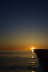 Sunrise over palma de port de pollensa beach in Mallorca, Spain with jetty / pier 