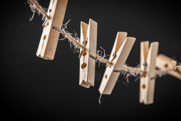 Macro shot of the wooden clothespins on the black background