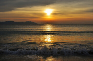 Naklejka na ściany i meble Sunset background on the sea coast