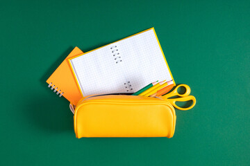 School accessories on green background. Back to school. Flat lay, top view, copy space