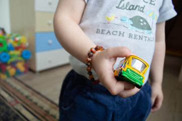 young boy  holding a toy car