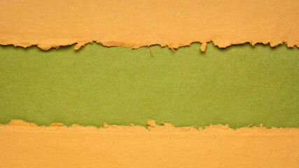 Fototapeta premium orange and green paper abstract with a copy space - sheets of bark and cotton rag paper, blank web banner