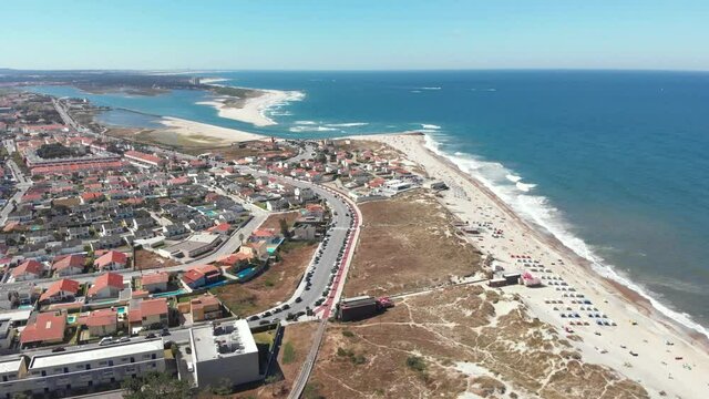 DRONE AERIAL FOOTAGE The marginal riverside, along the mouth of the Cavado River in Esposende, Portugal. The two sides of Restinga de Ofir. One facing the ocean, the other the estuary of C&aacute;vado River.