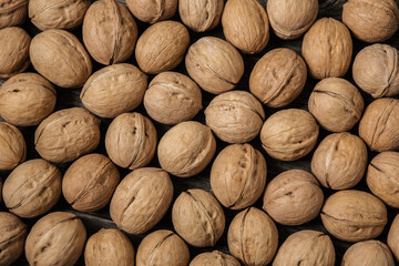 A lot of walnuts,  Juglans regia as background texture closeup, top view