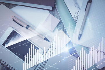 Multi exposure of forex graph hologram over desktop with phone. Top view. Mobile trade platform...