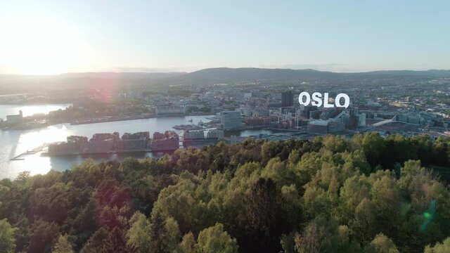Aerial view of downtown Oslo waterfront with 3D text behind Barcode buildings