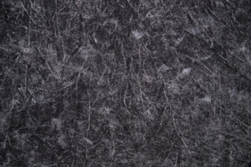 Texture of cotton jersey boiled, black and gray spotted. Background, close-up.