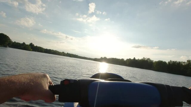 POV of Sea Doo ride during sunset on serene lake in Michigan