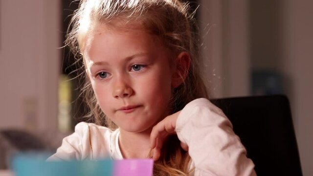 Young girl sad at the dinner table