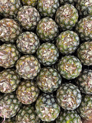 Fototapeta na wymiar A group of pineapples exposed in a supermarket
