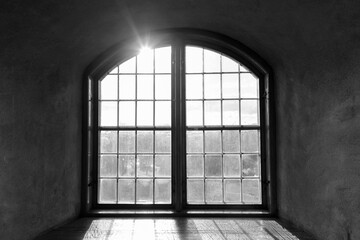 Closed wooden vintage window cemented on brick wall with natural view and sunlight streaming in