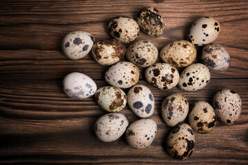 Quail eggs on a dark brown wooden background
