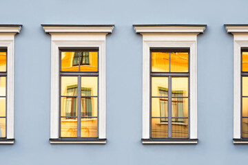 Reflections of old buildings in the windows, classic urban architecture background