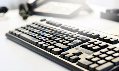 a black computer keyboard on an office table. Shallow depth of field. Occupation and office work