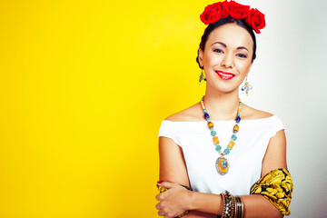 young pretty mexican woman smiling happy on yellow background, lifestyle people concept