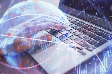 Double exposure of woman hands typing on computer and forex chart hologram drawing. Stock market analysis concept.