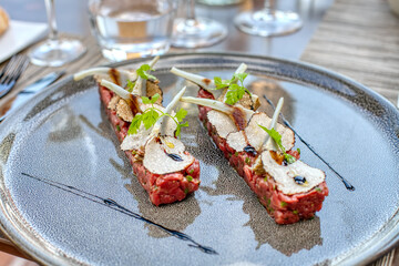 Beef tartar with black truffles and artichoke