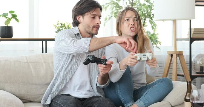 Crazy couple enjoying playing video game at home during weekend