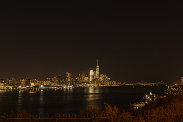 Fototapeta na wymiar New York City skyline at night with Verrazano bridge in the background, from New Jersey
