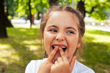 Fototapeta premium little cute caucasian girl playing cheerful in green park at summer, lifestyle people concept