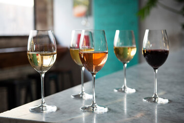 Many glasses of wine on a bar