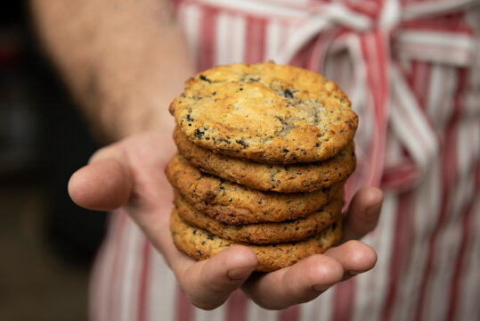 Person holding a stack of cookies
