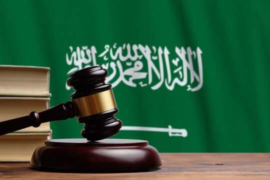 Justice and court concept in Kingdom of Saudi Arabia. Judge hammer on a flag background
