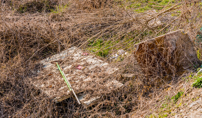 Mop handle on top of large pieces of wood
