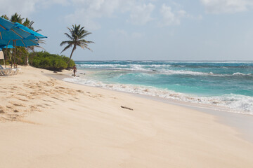 Beach with white sand, crystal clear water and palm trees