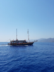 Pirate ship sails the sea, landscape, mountains