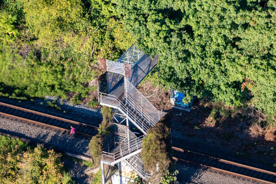 Aerial View Of A Pedestrian Bridge Over The Railroad In The Forest