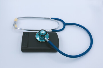 External Computer hard drive and a stethoscope  on a white