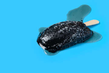 chocolate flavor popsicle shredded coconut melting on blue background