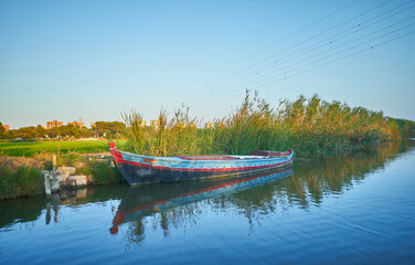 Fototapeta premium Albufera canal boats in El Palmar de Valencia Spain