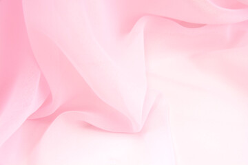 Fototapeta na wymiar Pink satin fabric with delicate curves